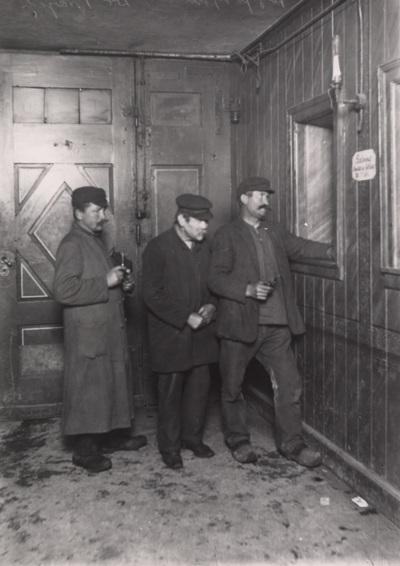 Tre mænd ved indgangen til herberget for hjemløse